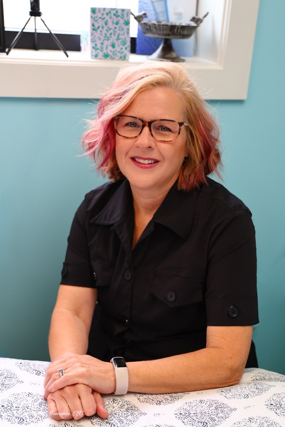 Lori Carlson, licensed esthetician, seated in her Greenwood studio